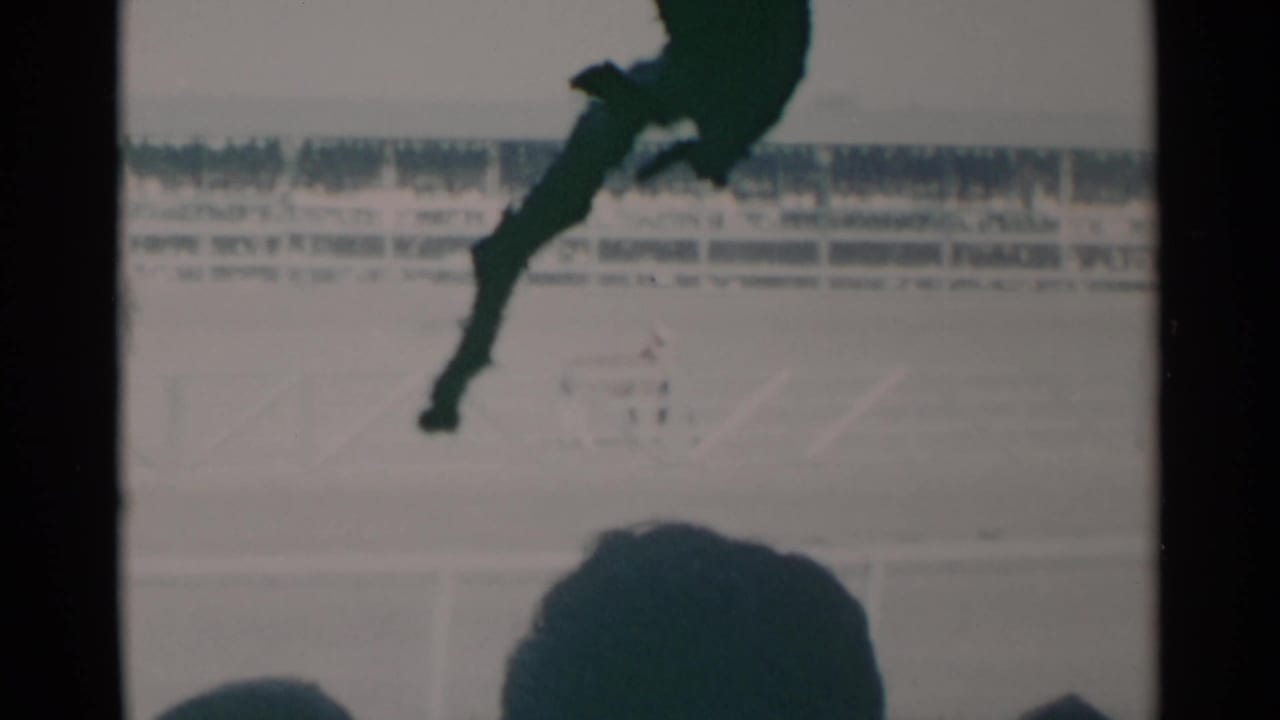 Cheyenne, Wyoming 1960 race footage with a horse and jockey partly silhouetted against a bright track scene.