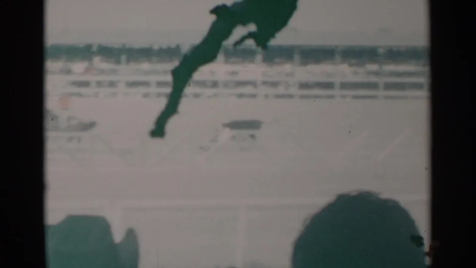 1960 Cheyenne arena frame showing horse action with a small dog near the track and spectators at the bottom edge.