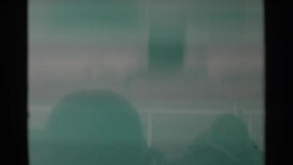 End frame of the 1960 Cheyenne rodeo clip, showing a faded arena view with spectators and railings as the action moves out of view.