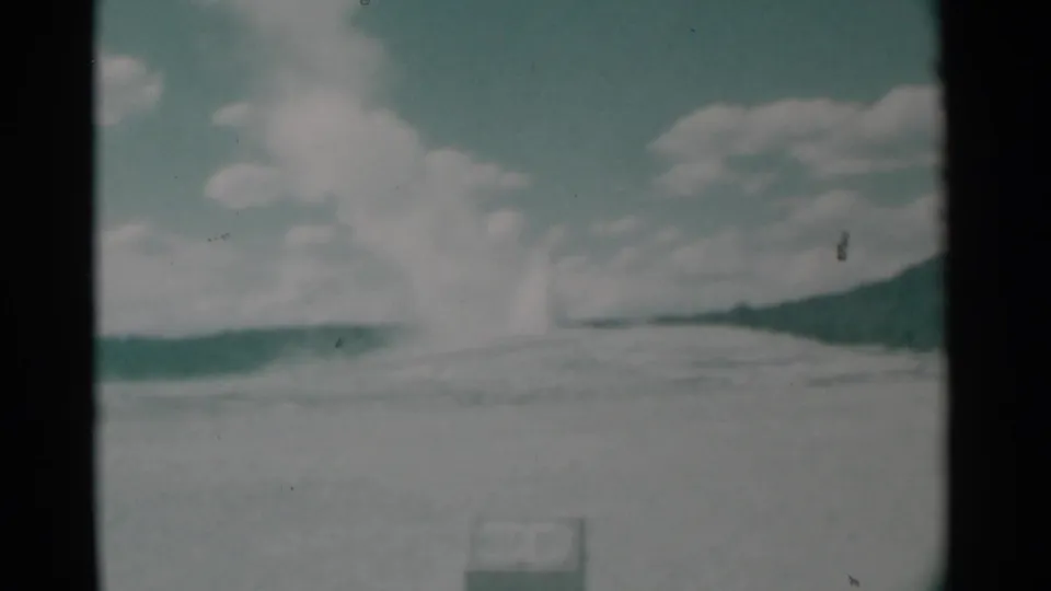 The distant plume appears to drift across the open Cheyenne-area landscape, recorded in soft 8mm color.