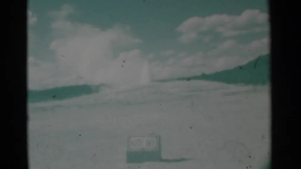 1961 Cheyenne, Wyoming 8mm frame showing a washed-out distant horizon, cloudy sky, and possible bright plume through heavy film wear.