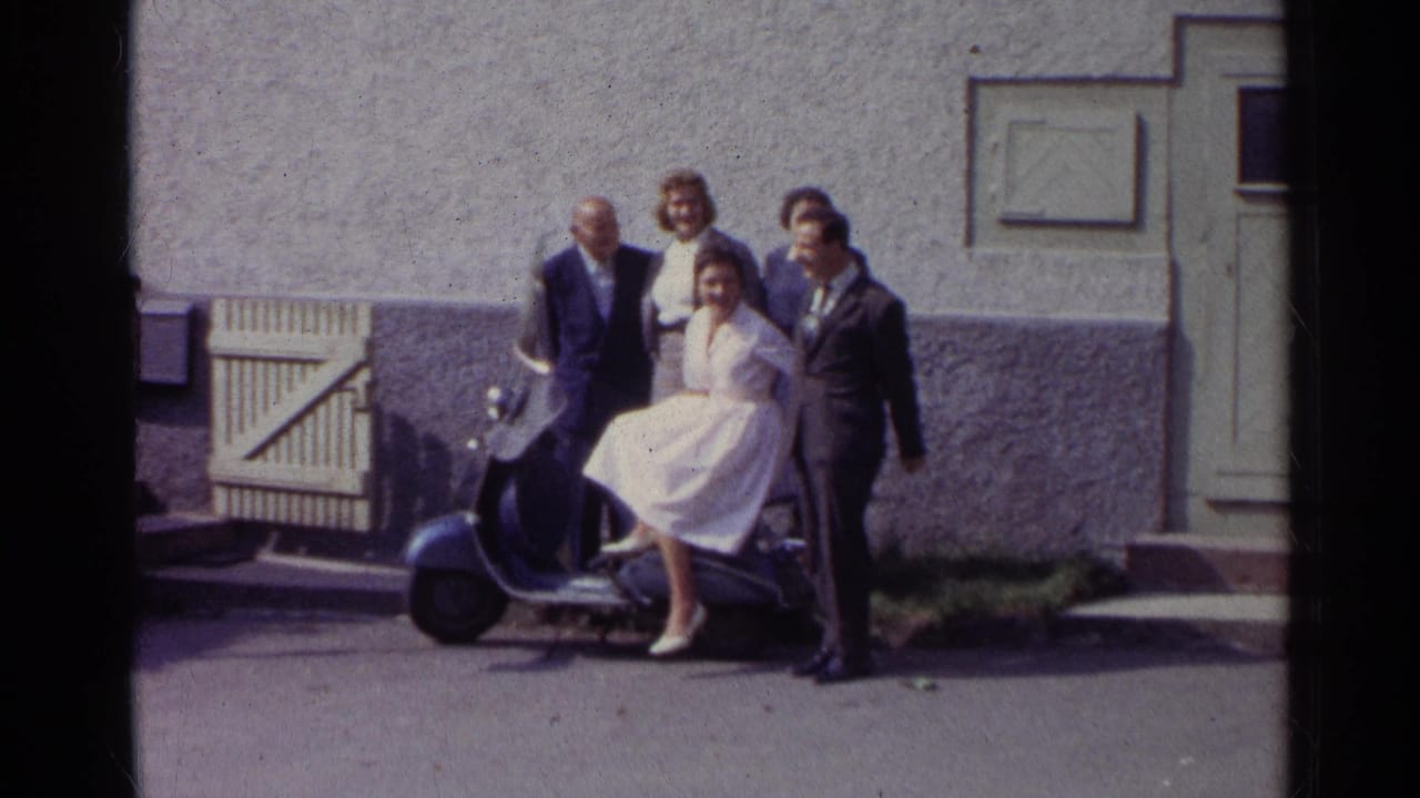 Group smiles beside a scooter with a seated woman in a white dress.
