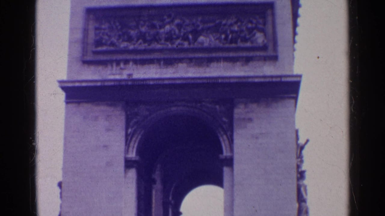 Close view of the Arc de Triomphe upper arch and carved frieze with purple film tint.