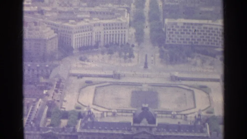 1961 Paris aerial view showing city blocks, a vertical monument, tree-lined avenues, and the formal garden at the lower edge.