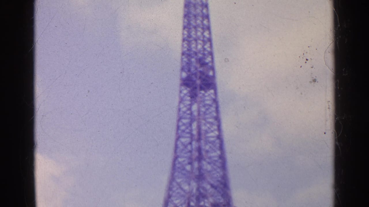 Closer low-angle framing of the Eiffel Tower structure and sky.
