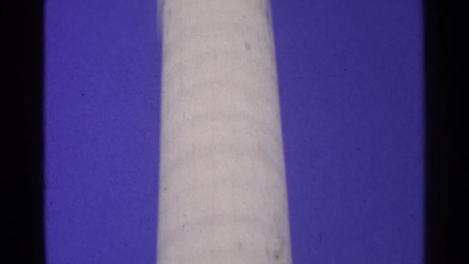 1961 Switzerland 8mm still showing the pale cylindrical form continuing through the frame with blue sky and archival film marks.