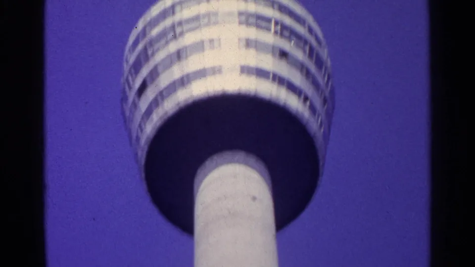 Low-angle 1961 Switzerland view of the TV tower's circular observation deck with horizontal window bands.