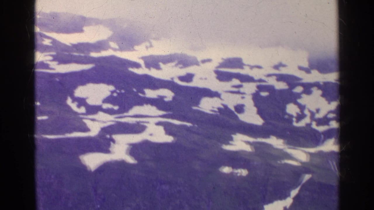 Swiss 8mm travel footage from 1961 showing a snow-marked mountain range softened by mist and color shift.