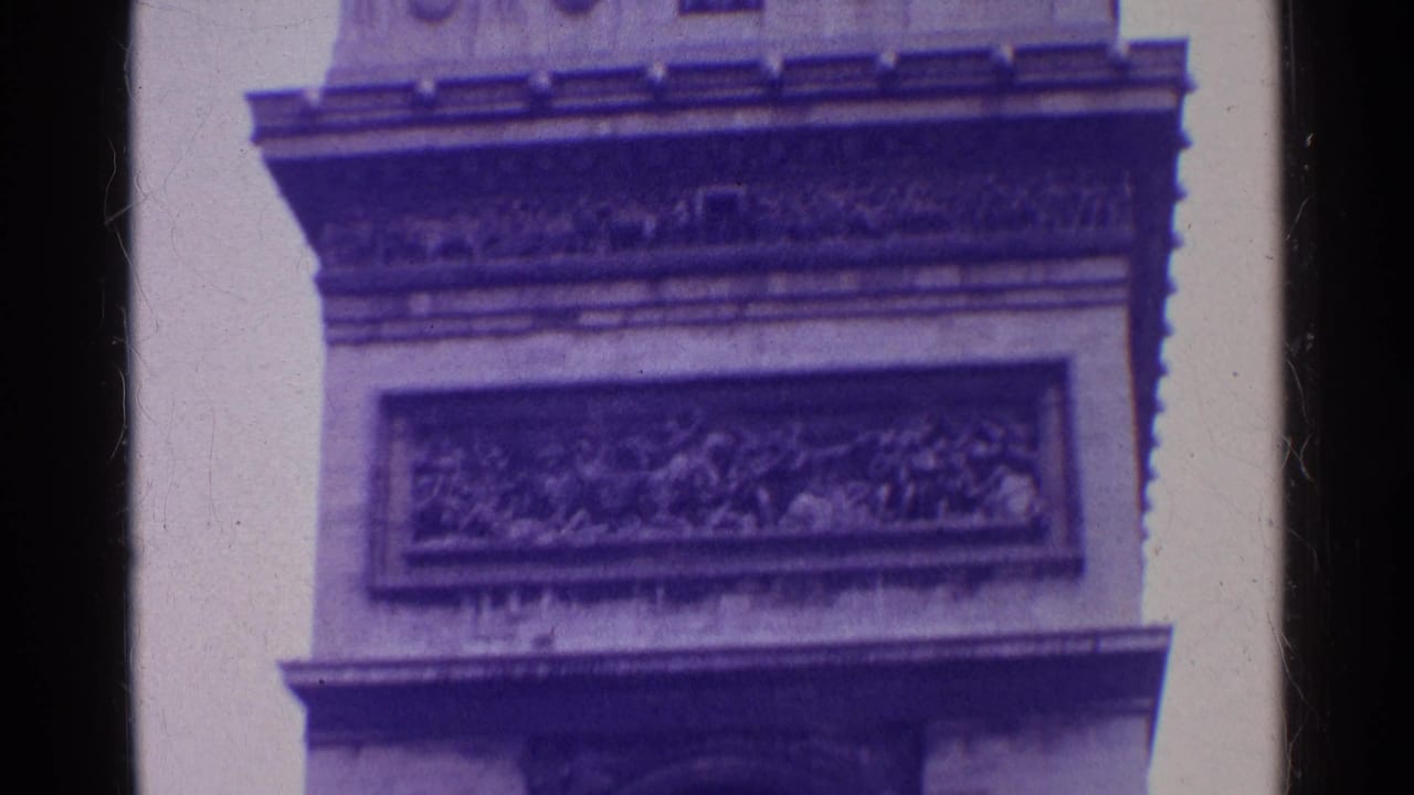 Vintage 8mm travel frame showing a close architectural detail of a triumphal arch, including carved frieze, stone ledges, and dark arch opening.