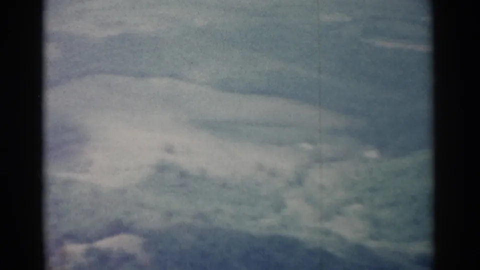 1962 8mm landscape near Jamestown with pale cloud cover over a distant, softly focused ridge.
