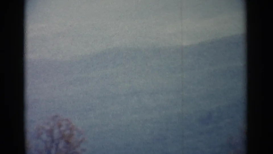 1962 8mm landscape near Jamestown with a subdued hillside view and faint foreground trees.