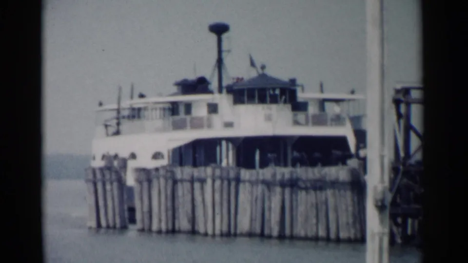 The closing frame shows a ferry docked beside wooden pilings on the water, consistent with the Jamestown, Virginia travel setting.
