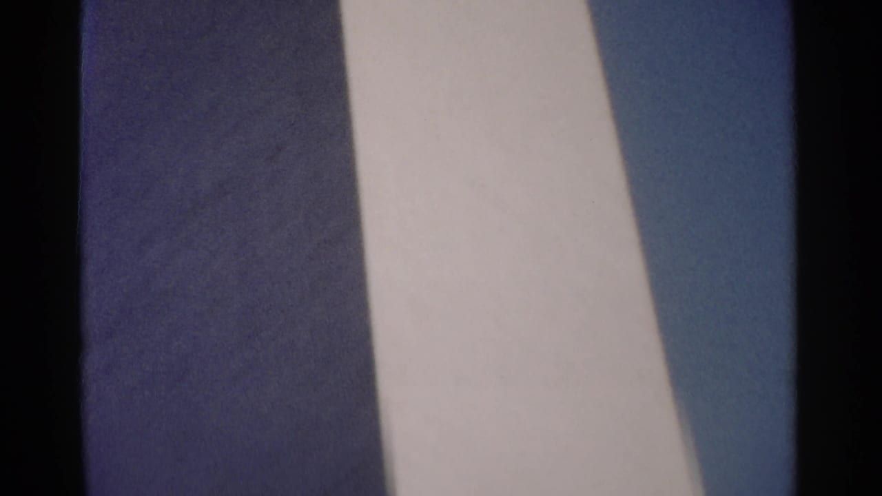 Soft 8mm view of tall pale and blue-gray stone architectural surfaces.