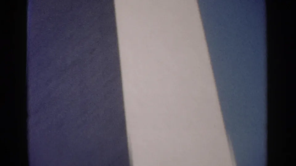 1962 Washington DC home-movie frame showing abstracted vertical stone surfaces from a landmark exterior during a handheld pan.