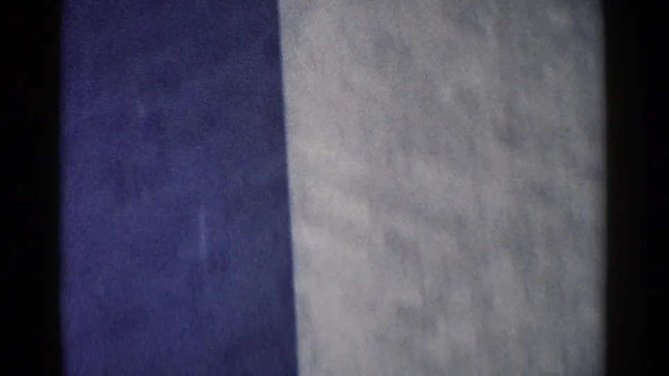 Handheld 8mm frame of a large Washington DC stone exterior, with the camera still settling from the downward pan.