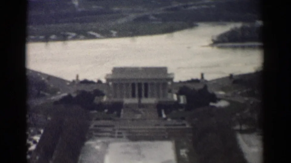 1962 aerial frame of the Lincoln Memorial area in Washington, DC, with the river and mall grounds visible beyond.