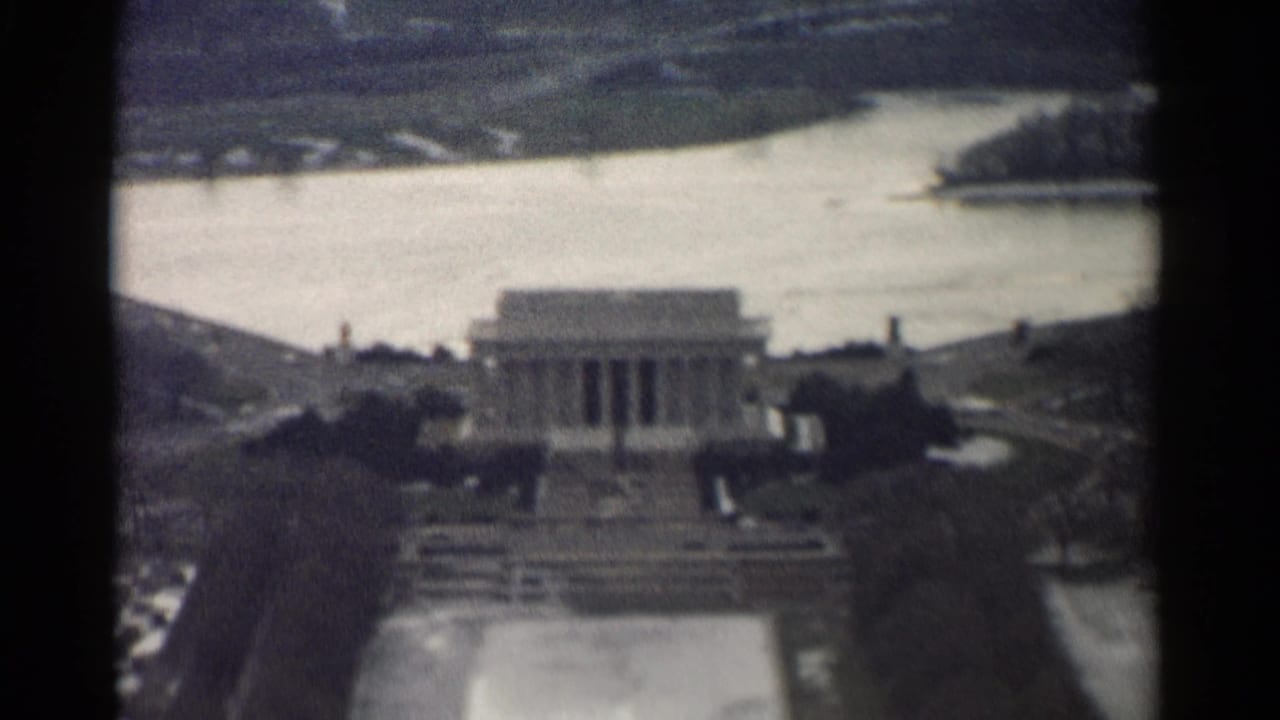 Elevated view of the Lincoln Memorial with water and parkland behind it.