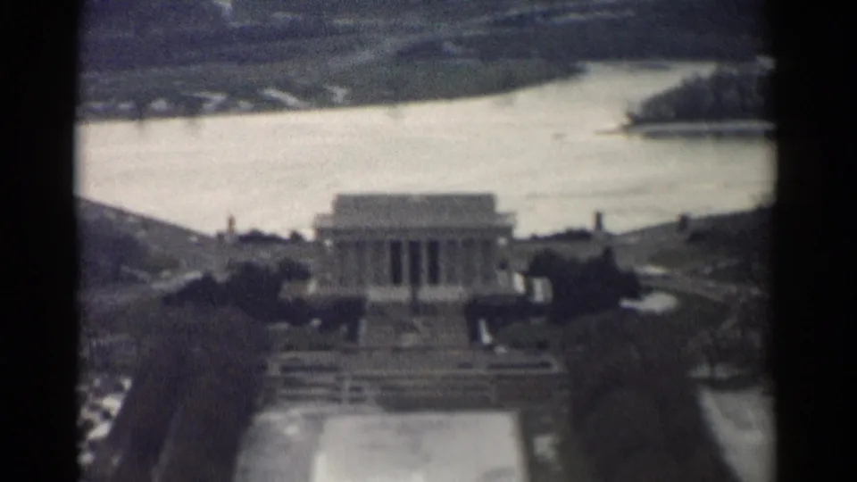 1962 8mm Washington, DC view looking toward the Lincoln Memorial, with water, trees, and distant city detail beyond.