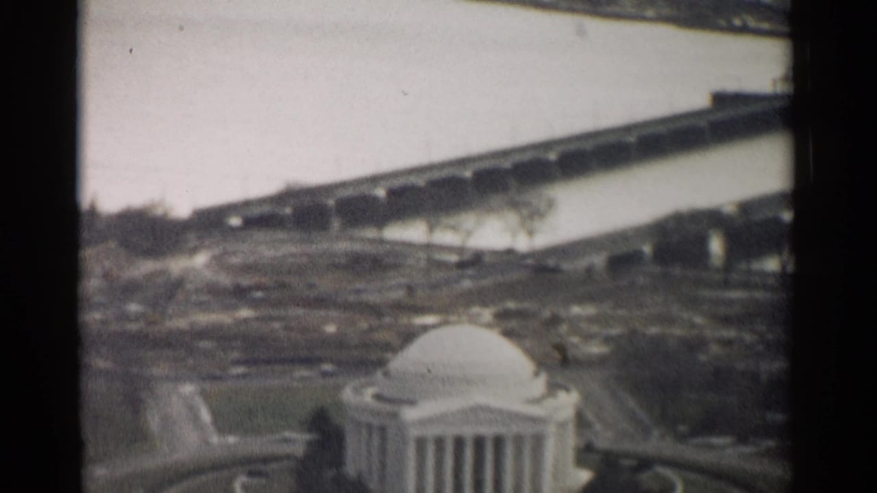 Jefferson Memorial seen from above with Tidal Basin and a distant bridge.