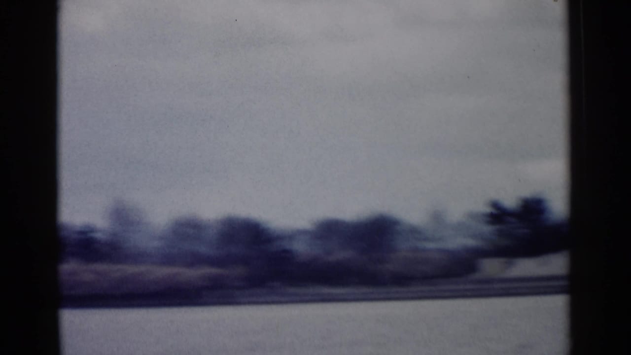 1962 8mm Washington DC footage looking across water toward a low shoreline, with the memorial not yet clearly visible.