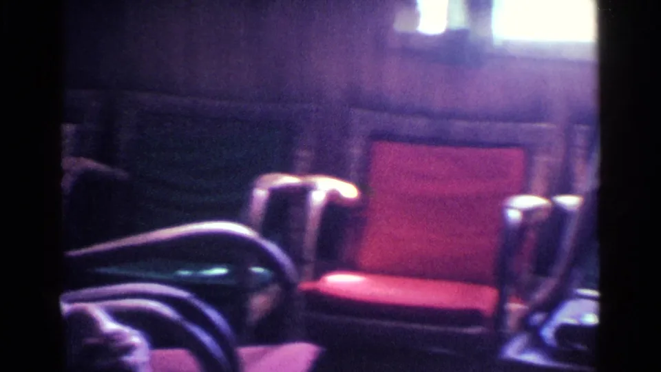 The final frame pans to a red cushioned chair and surrounding armchairs in the same Kentucky living-room interior.