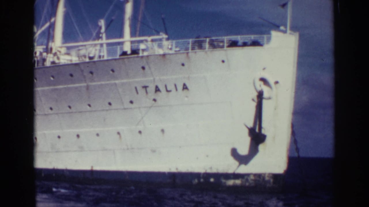 Closer view of the Italia bow with the painted ship name, anchor, railing, and sea visible.