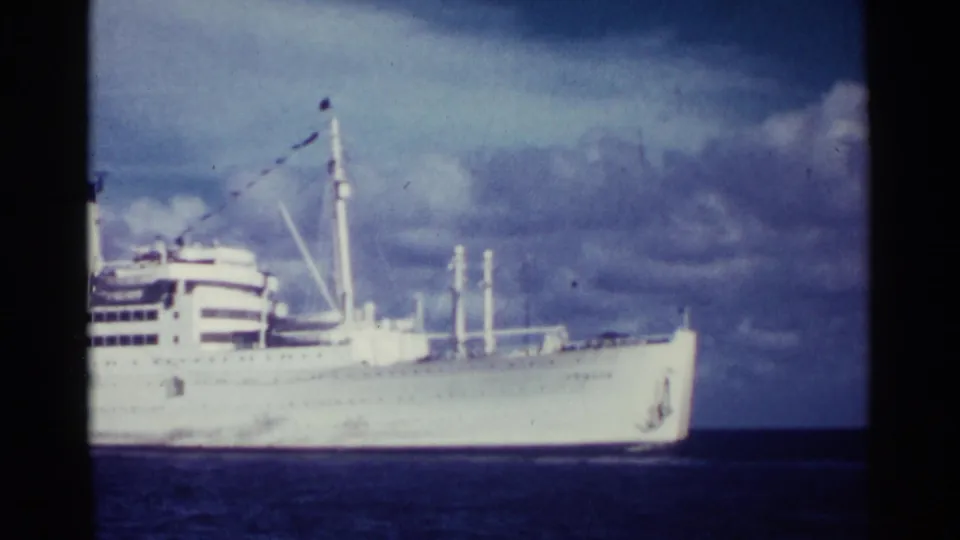 1963 Nassau footage frame with the passenger liner partly centered, showing its bow, decks, funnel, and masts.