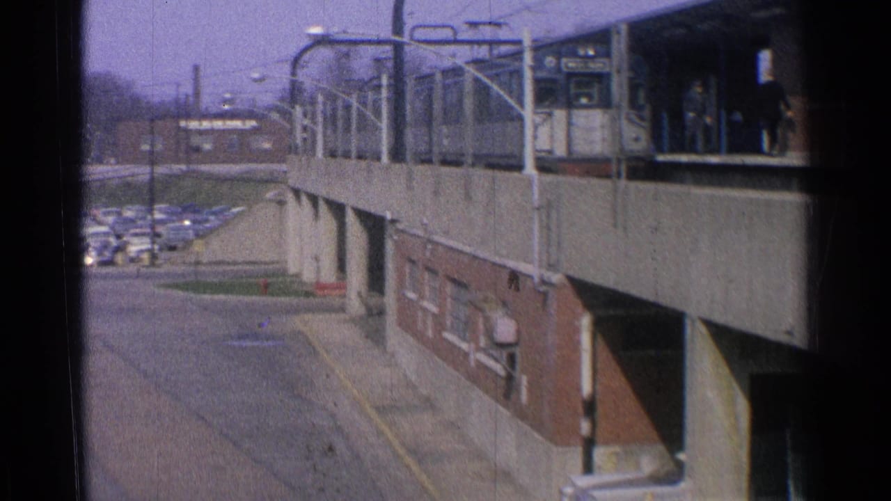 Elevated trolley platform with waiting passengers and a road below.