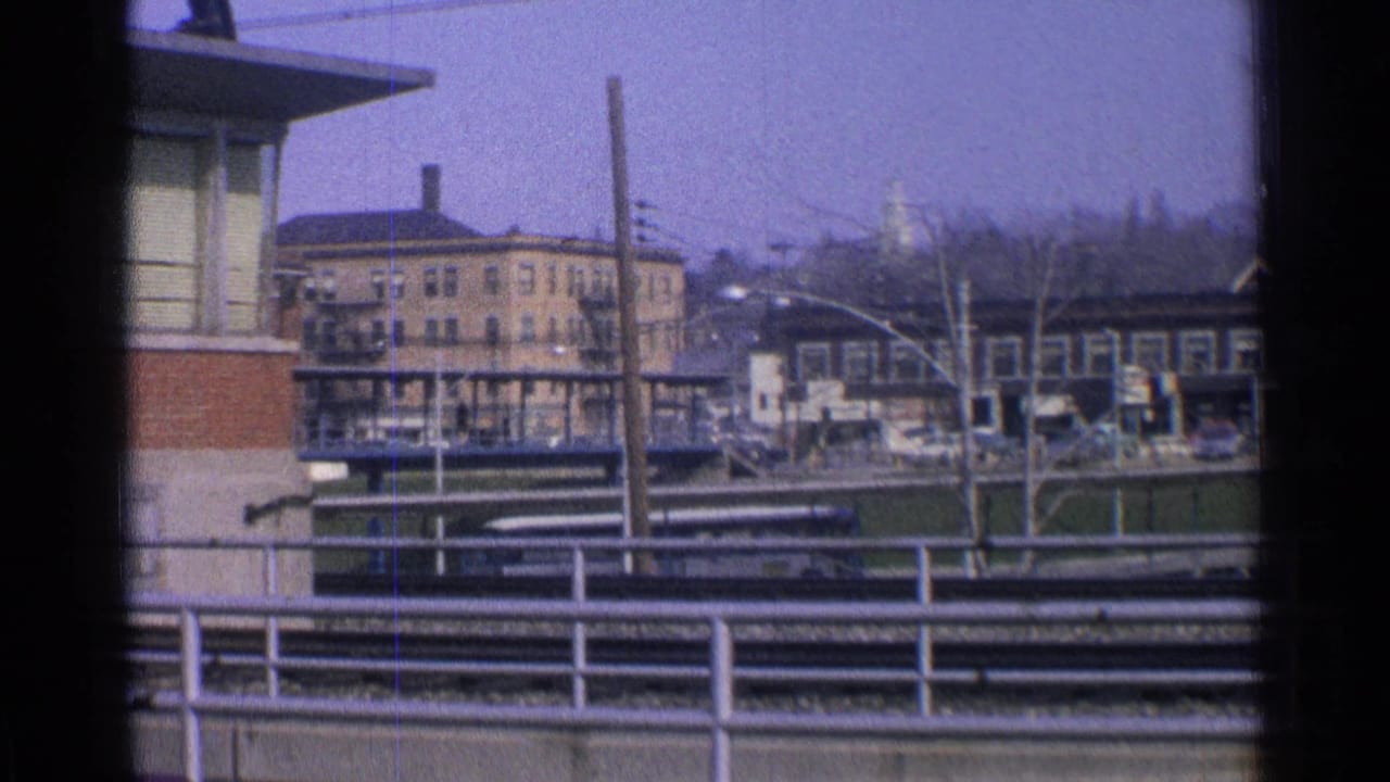 Station buildings and elevated rail line after the train has passed.