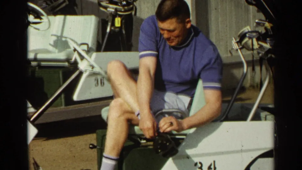 A 1968 Scottsdale golf-course moment shows a man on a cart adjusting his shoe beside clubs and cart hardware.
