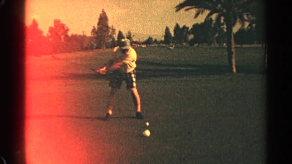 The Scottsdale golfer starts a compact swing on the course, with warm 8mm color and red edge flare visible.