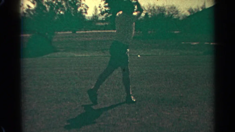 The golfer completes the practice swing with the club high above him on a sunlit Scottsdale range in 1968 footage.