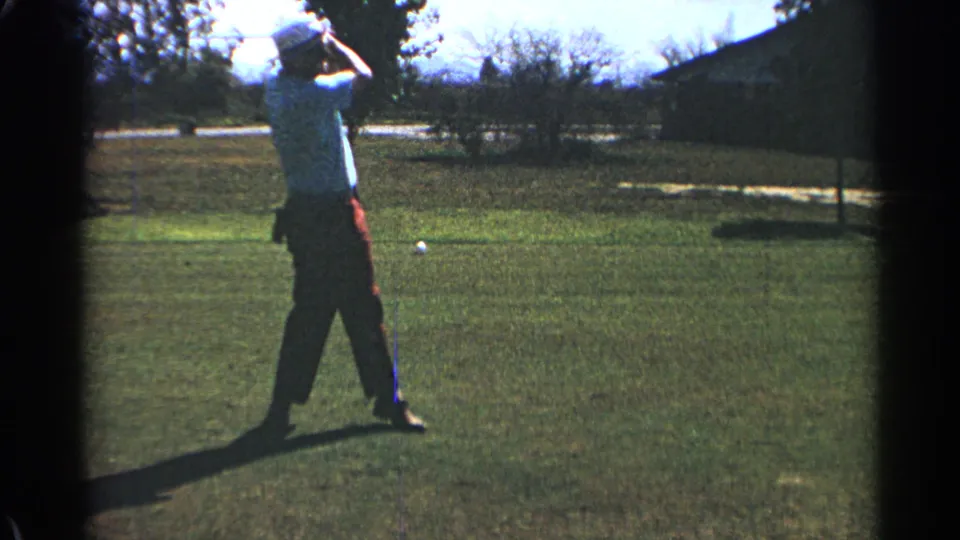 In 1968 Scottsdale, the golfer stands in follow-through with the club over the shoulder on a sunlit green lawn.