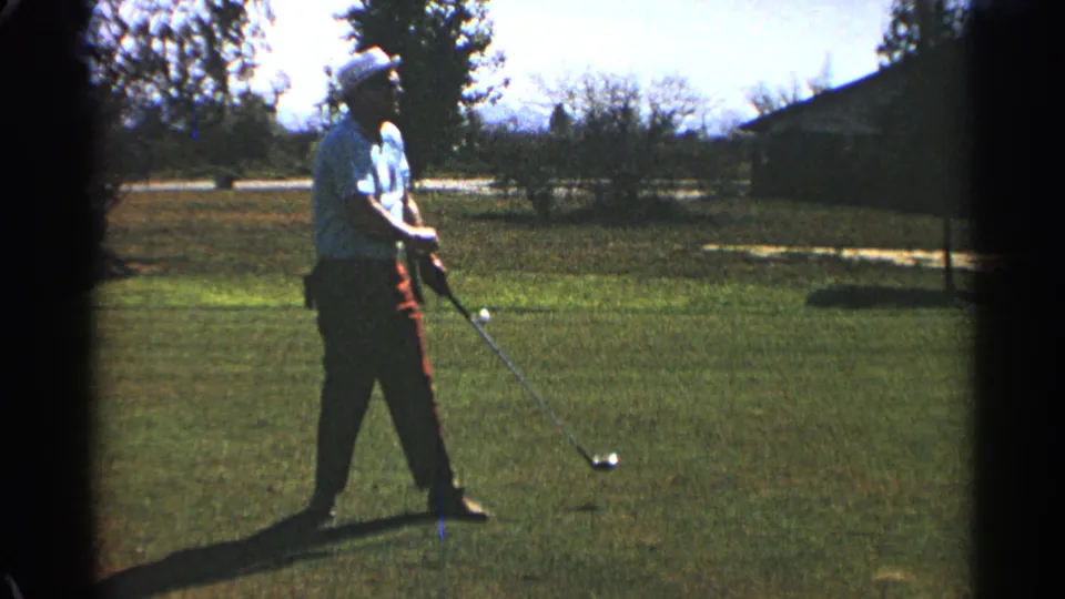 In the Scottsdale 1968 golf scene, the golfer stands in profile with the club angled down and the ball visible on the grass.
