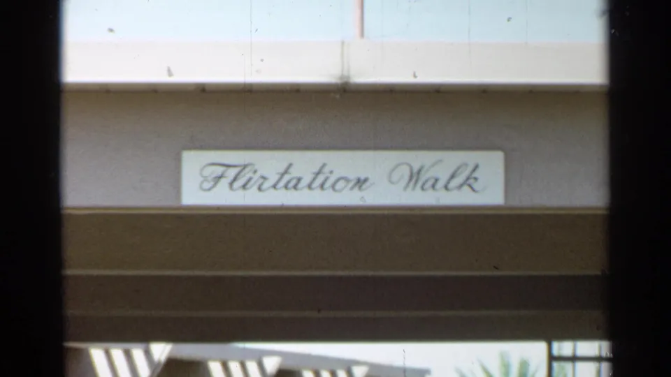 A resort-style exterior sign reading Flirtation Walk appears above shaded beams in the 1968 Scottsdale footage.