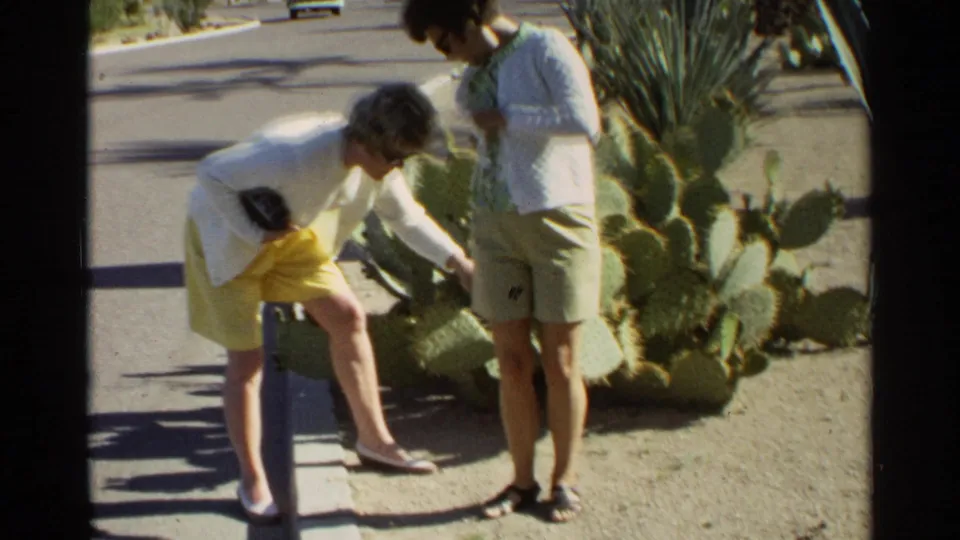 The Scottsdale home movie shows one woman leaning over near prickly pear cactus while another stands nearby in shorts.