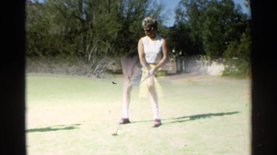 Adult woman in sunglasses takes her stance with a golf club on a bright Scottsdale golf course, supported by the 1968 clip metadata.