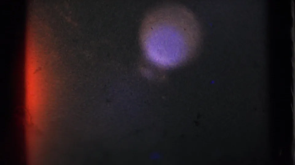 The final frame shifts to mostly dark film with red and purple light leaks, likely an in-camera or reel-end artifact.