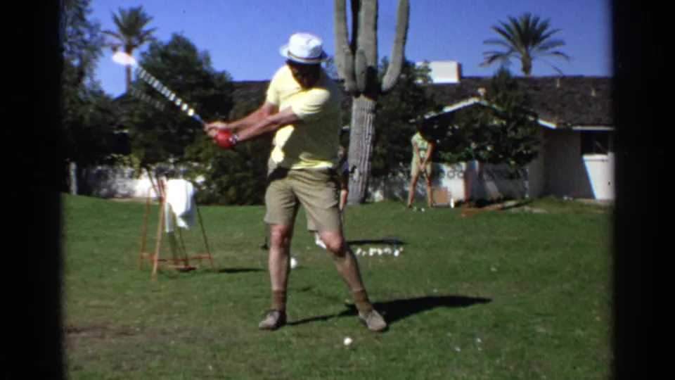 A 1968 Scottsdale backyard frame shows the golfer mid-swing with a ball in the foreground, a saguaro cactus beside him, and a house and palms behind.