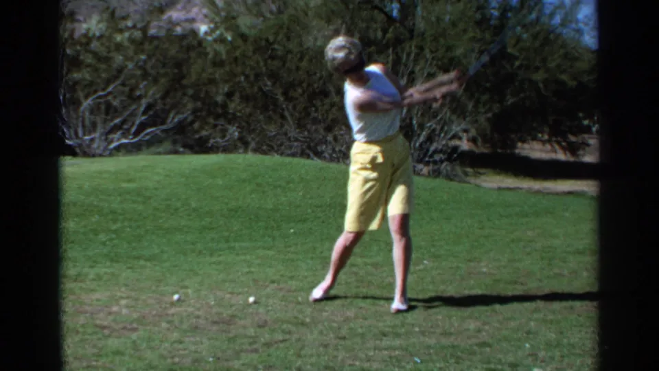 The 1968 Scottsdale home-movie footage shows the woman in mid-swing, rotating through the shot on the golf course.