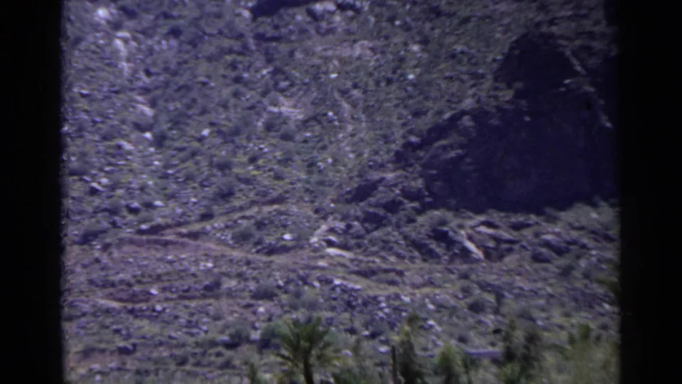 Rocky desert hillside and sparse vegetation appear near the Scottsdale golf course in 1968 home-movie footage.