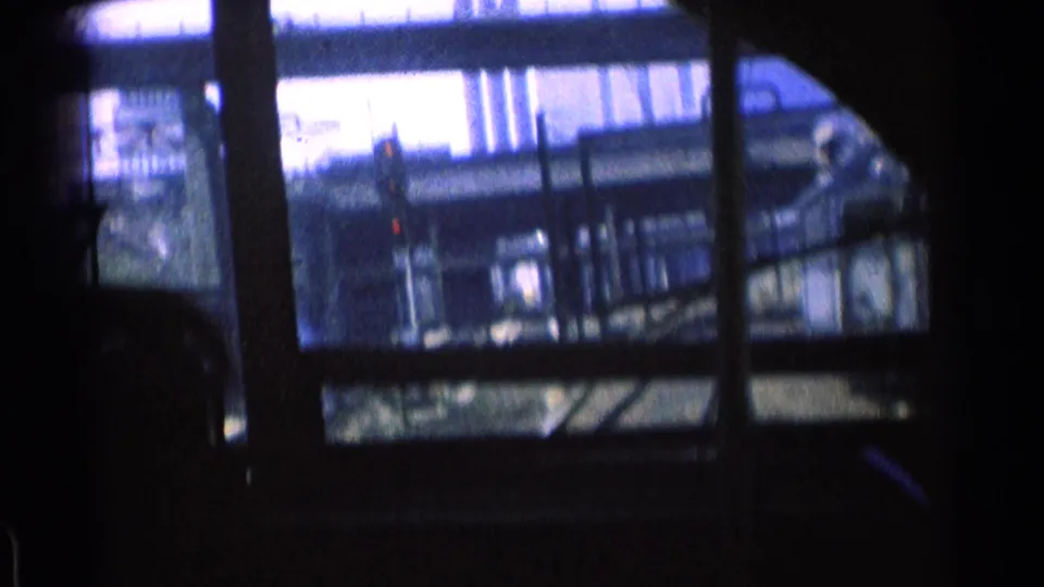 At the end of the clip, the 1976 Chicago rail corridor remains visible through dark window framing, with tracks and steel supports outside.