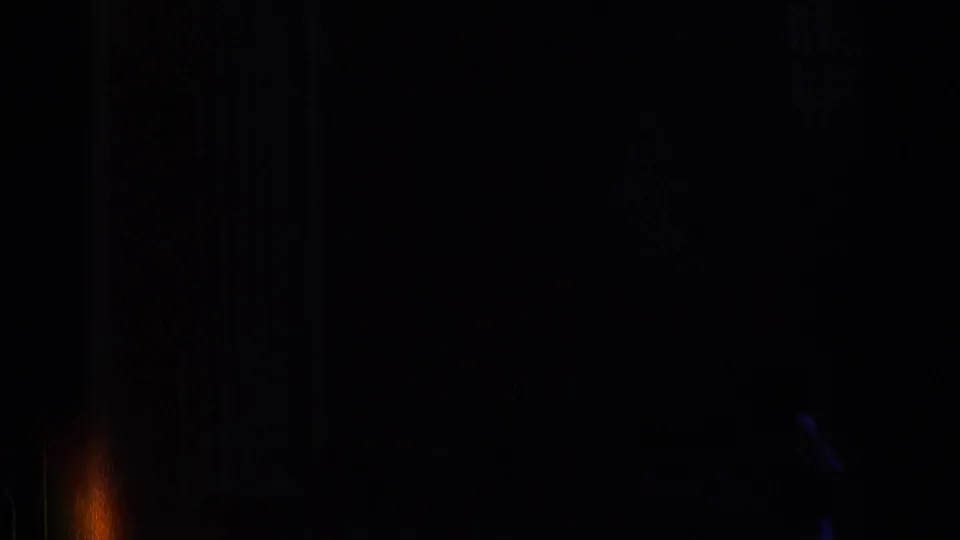 Dark, underexposed end frame from the 1976 Chicago 8mm clip, with faint film bands and minimal readable street detail.