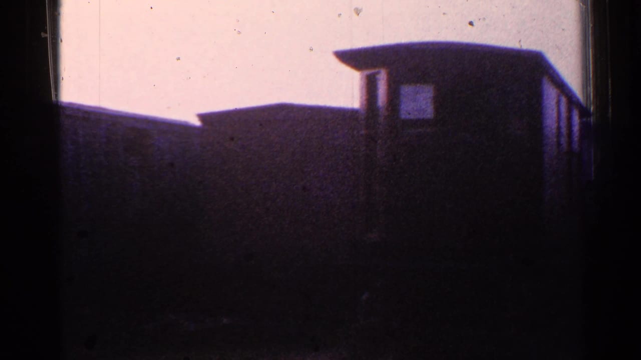 Dark trailer or shelter row with small windows in low light.