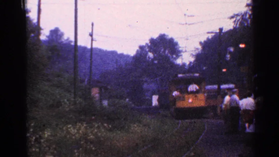 A 1953 Connecticut 8mm frame captures the train at the platform area with passengers waiting nearby.