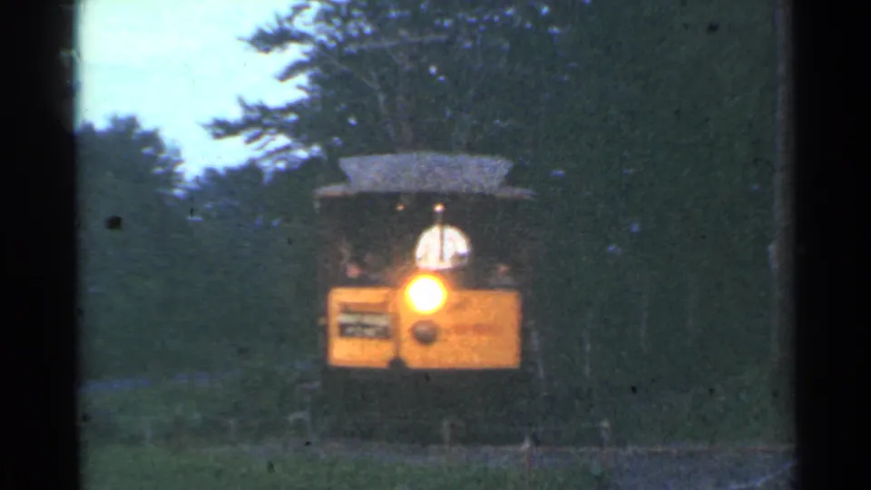 The tram reaches a close position in the wooded Connecticut scene, with its bright headlight blooming in the 8mm exposure.