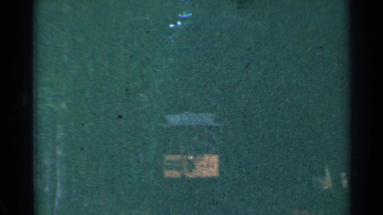 Dark-edged frame with a green-tinted area and a faint yellow rectangular shape.