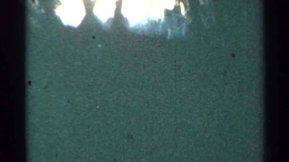 1953 Connecticut train POV with dark window edge, green trackside blur, and abstract reflected light.