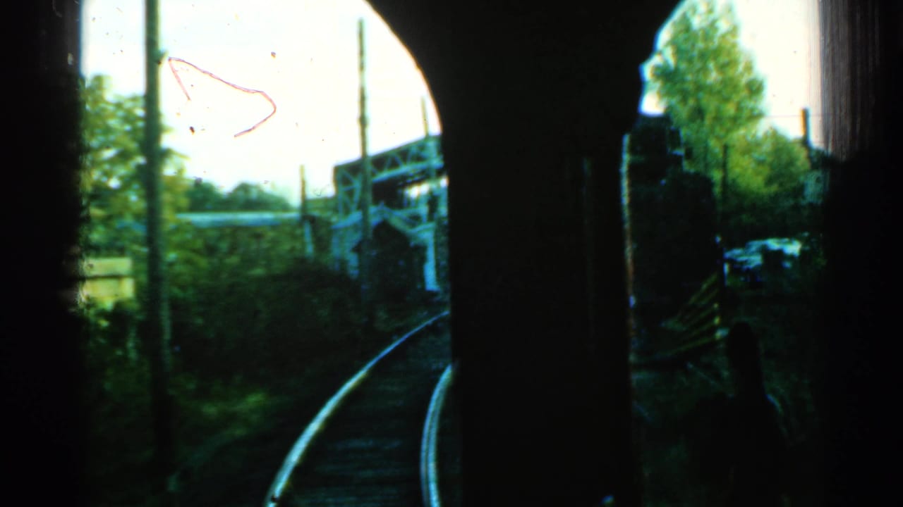 1953 Connecticut train-window view of tracks curving toward a possible concrete bridge or overpass.