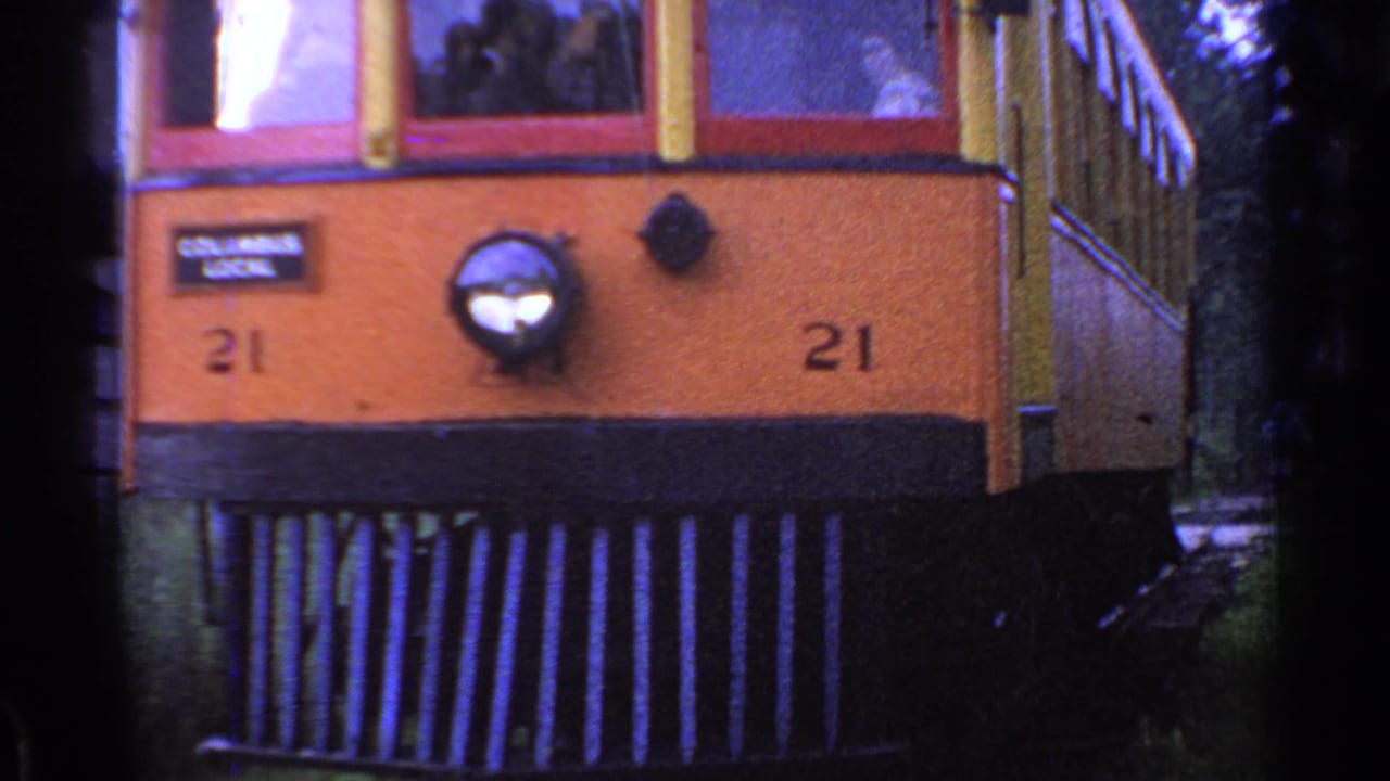 Closer front view of trolley number 21 with route sign and headlamp.